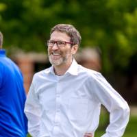 A player stands with hands on hips smiling